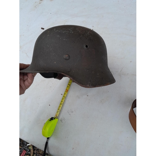 59 - German World War II era field helmet