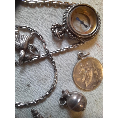 278 - Silver jewellery including damaged spinning fob on necklace, various charms, compass fob etc.