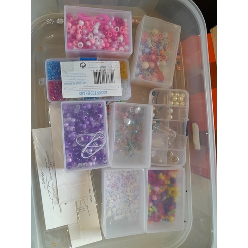 73 - Costume jewellery in a tiered plastic carrier