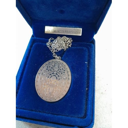 106 - QEII commemorative silver pendant and silver bracelet