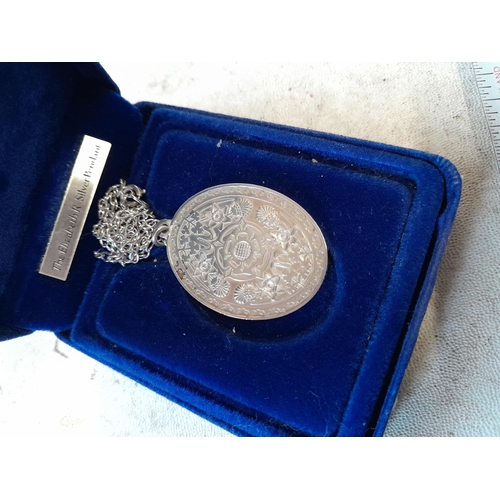 106 - QEII commemorative silver pendant and silver bracelet