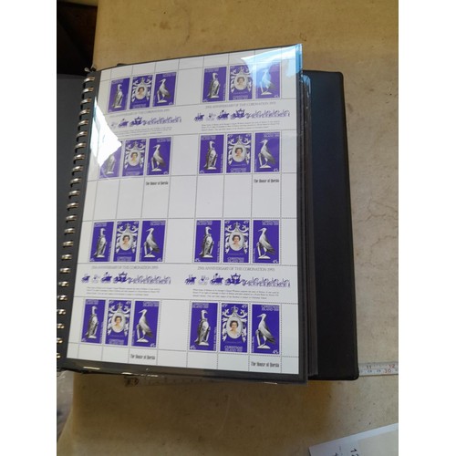 120 - Stamps :  25th Anniversary of the Coronation Commemorative stamp albums, 2 x sparsely filled albums ... 