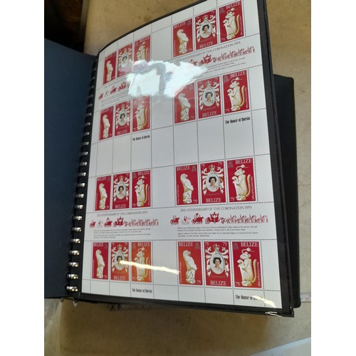 120 - Stamps :  25th Anniversary of the Coronation Commemorative stamp albums, 2 x sparsely filled albums ... 