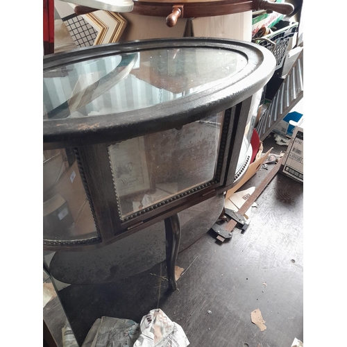 43 - Early 20th century oak display cabinet of oval form bevelled glass surround, note crack to top