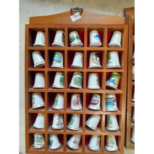 12 - Collection of porcelain thimbles in racks