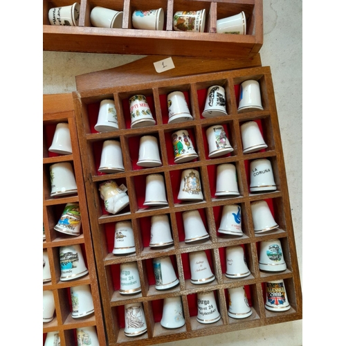 12 - Collection of porcelain thimbles in racks