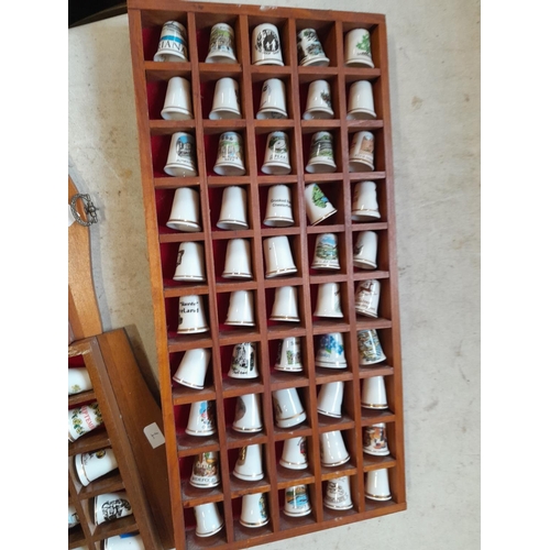 12 - Collection of porcelain thimbles in racks