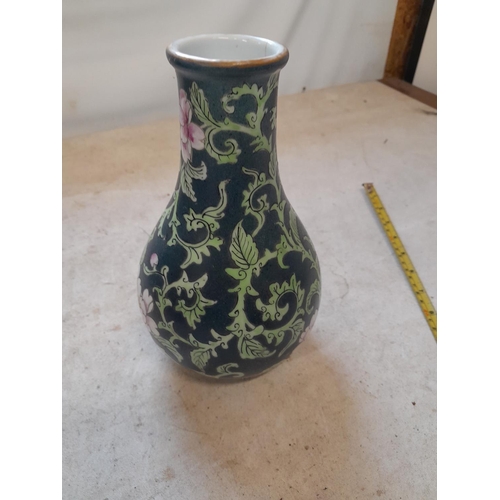 438 - Very interesting Chinese Famille Rose vase of baluster form terminating on tripod feet, with dark gr... 