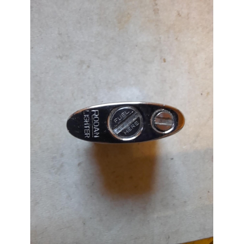 657 - Very rare Rodan pocket lighter, with floral decorated white metal jacket, from the 1950s