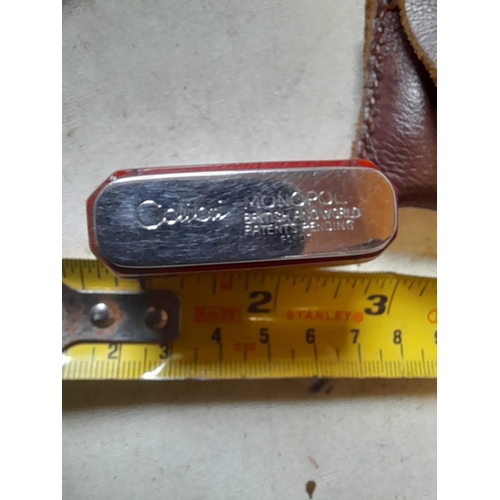 662 - Colibri Monopol pocket lighter in  leather pouch, British and World Patents Pending