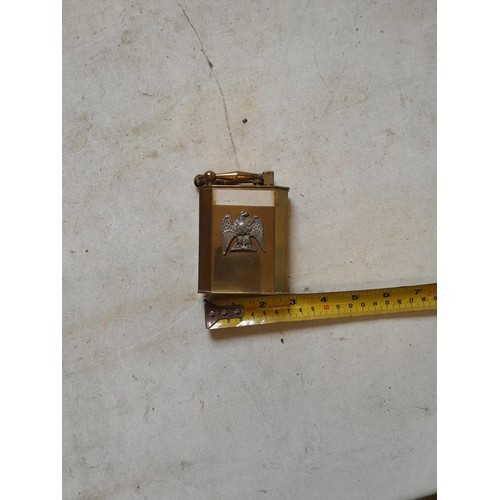 666 - Large brass table lighter with white metal eagle bird motif on front, in need of some repair, govern... 