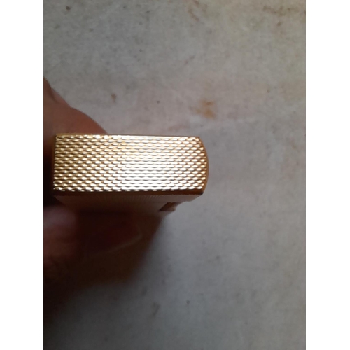 677 - Dunhill gold plated gas lighter with engine turned decoration, made in England on internal cap in ne... 