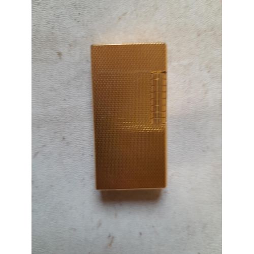 677 - Dunhill gold plated gas lighter with engine turned decoration, made in England on internal cap in ne... 