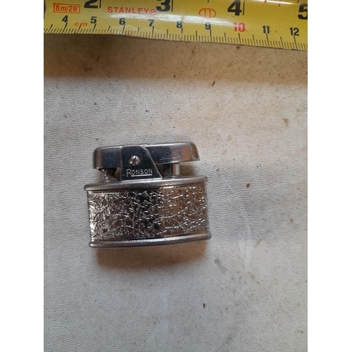 687 - Vintage ladies Ronson petrol lighter with floral decoration Pat No. 621570 in good order