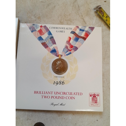 182 - Coins : 1986 Olympic £2 coin presentation pack with other coins