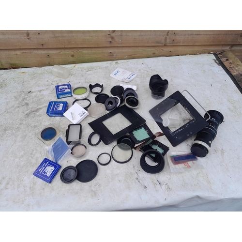 100 - Collection of assorted camera accessories, lens filters, duplicator etc.