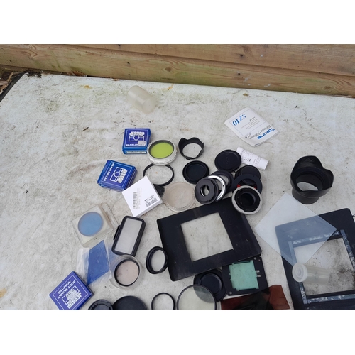 100 - Collection of assorted camera accessories, lens filters, duplicator etc.