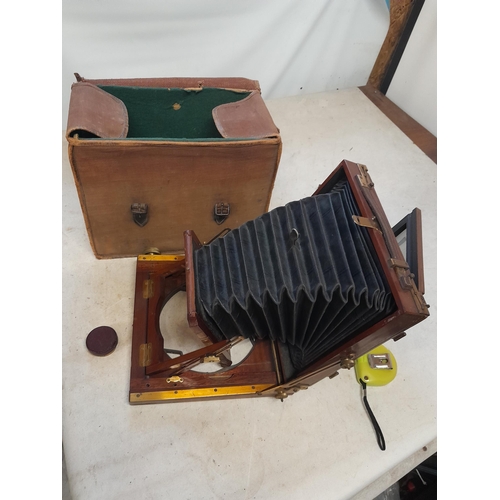 193 - Early 20th century bellows plate camera with mahogany body in  canvas case of issue