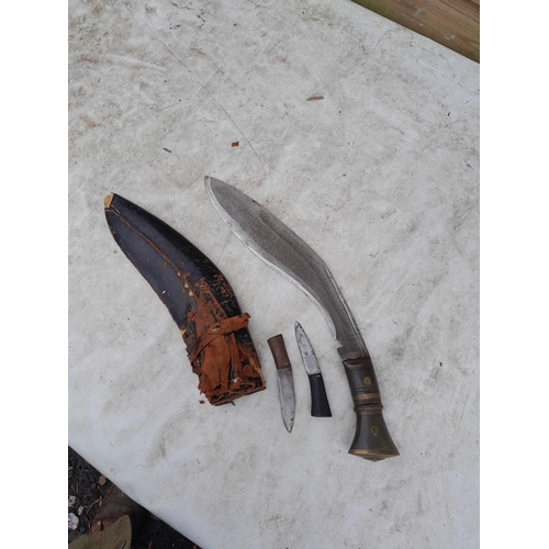 5 - Early 20th century Kukri knife in damaged leather covered sheath with two skinning knives