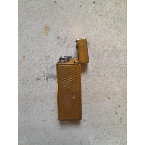 113 - Dunhill Unique  Rollalite petrol lighter with engine turned gild finish rubbed in places