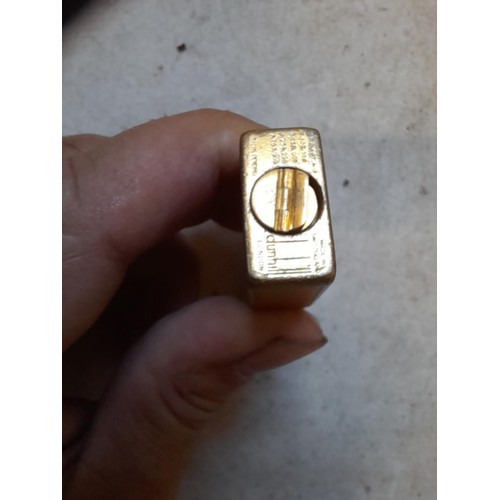 113 - Dunhill Unique  Rollalite petrol lighter with engine turned gild finish rubbed in places