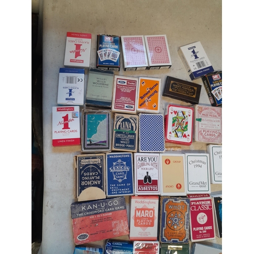 215 - Collection of assorted era playing cards and whist marker, some packs still sealed