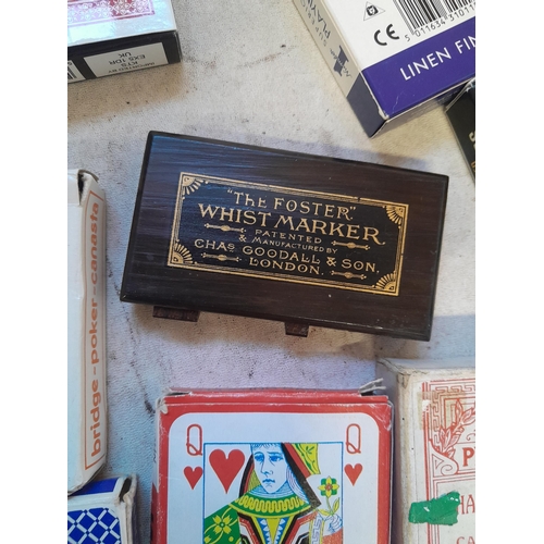 215 - Collection of assorted era playing cards and whist marker, some packs still sealed