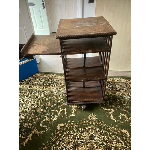 673 - Early 20th century oak revolving bookcase on later ball castors with fold down tray Dimensions 52cm ... 