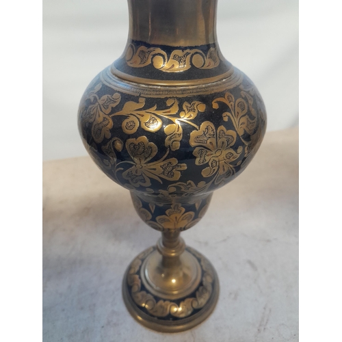 113 - Pair of 19th century Indian chased bronze vases with floral decoration and  black lacquer inlay