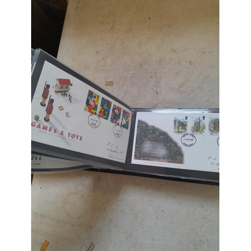 261 - Collection of Stamp First Day covers in three albums from the 1980s and Historic Vehicles coin set