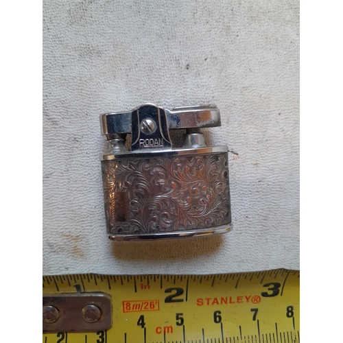 320 - Very rare Rodan pocket lighter, with floral decorated white metal jacket, from the 1950s