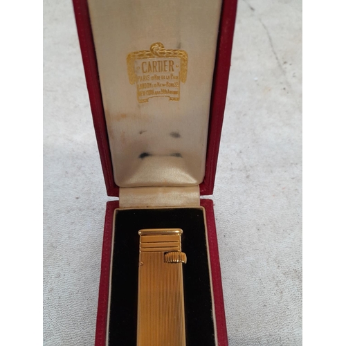 471 - A fine example of a Cartier ladies cigarette lighter in original box of issue, the engine turned dec... 