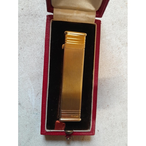 471 - A fine example of a Cartier ladies cigarette lighter in original box of issue, the engine turned dec... 