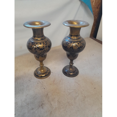 512 - Pair of 19th century Indian chased bronze vases with floral decoration and  black lacquer inlay