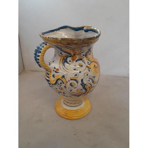 7 - An antique Italian polychrome maiolica jug with Armorial crest and further floral decoration, with f... 