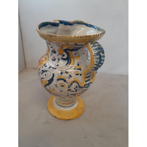 7 - An antique Italian polychrome maiolica jug with Armorial crest and further floral decoration, with f... 