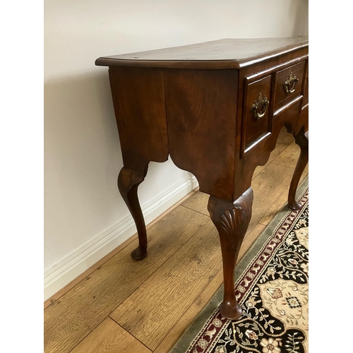 12 - George II walnut veneered lowboy with crossbanding and boxwood stringing on cabriole legs with shell... 