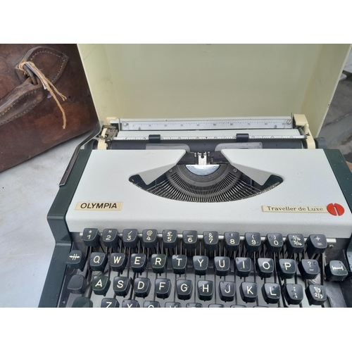 44 - Early 20th century leather case, not shutting well, Olympia typewriter, brass trumpet Lafleur, suitc... 