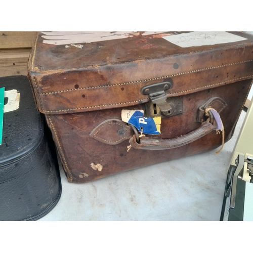 44 - Early 20th century leather case, not shutting well, Olympia typewriter, brass trumpet Lafleur, suitc... 