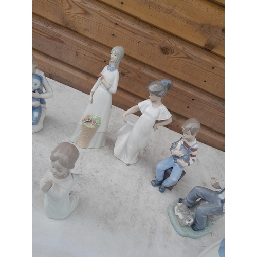 70 - Various Nao figures in good order and a collection of cottage resin and pottery ornaments