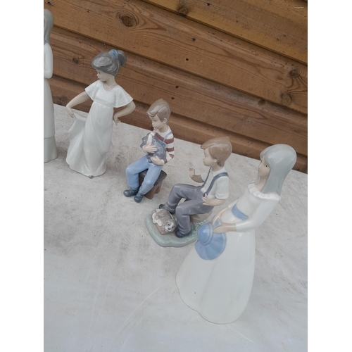 70 - Various Nao figures in good order and a collection of cottage resin and pottery ornaments