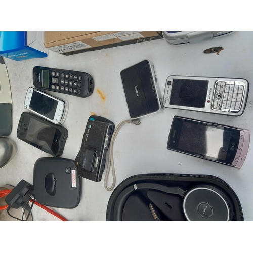 188 - Box of assorted electrical items : telephones and covers, headphones, hand held games console etc.