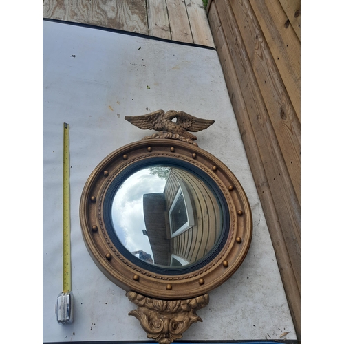 25 - Early 20th century gilt convex wall mirror with plaster eagle pediment