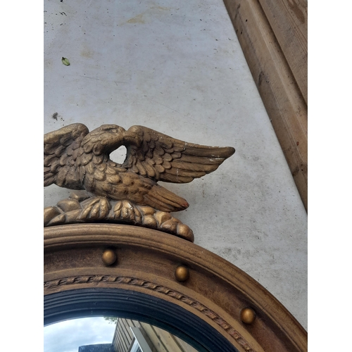 25 - Early 20th century gilt convex wall mirror with plaster eagle pediment