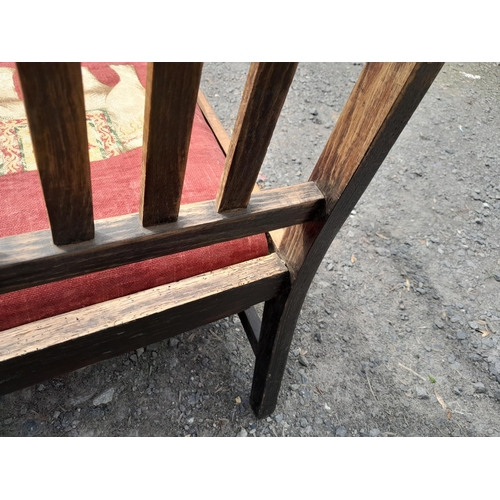 26 - Early 20th century oak settle with later upholstery, note wobble to arm, therefore light reglue and ... 