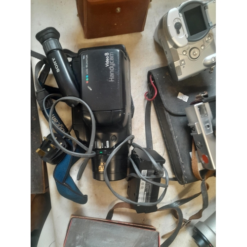 299 - Assorted cameras and accessories, handi cam etc.