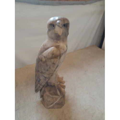 136 - Early 20th century carved marble eagle ornament with glass eyes  with later baize on base 35 cms