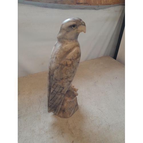 136 - Early 20th century carved marble eagle ornament with glass eyes  with later baize on base 35 cms