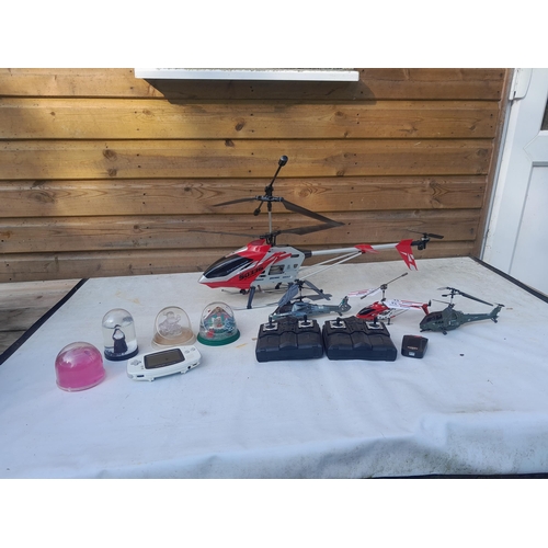 208 - Box of oddments : remote control helicopters & one other, Game Boy Advance & 4 x snow globes