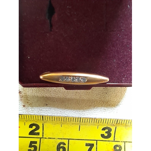 369 - 9 ct gold bar brooch with gold plated pin set with small diamonds 0.7 g in a H Samuel box